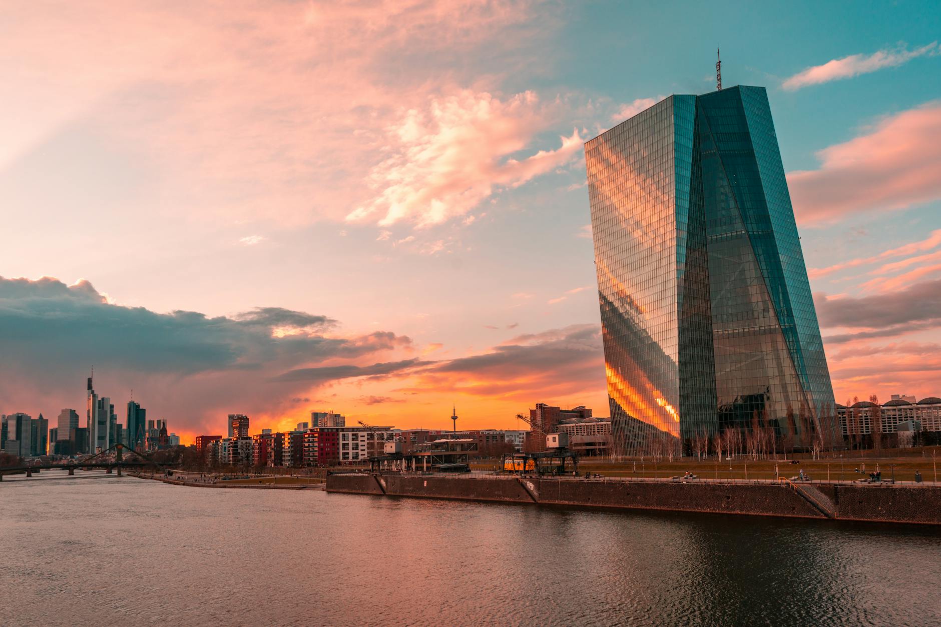 Stunning sunset over Frankfurt's skyline featuring the iconic ECB Tower and Main River.
